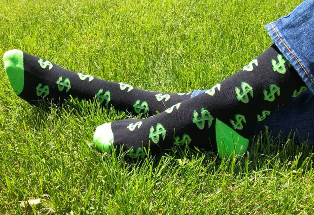 Money socks in the grass